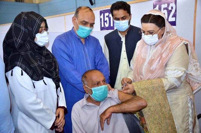 Dr. Firdous Ashiq Awan administers covid-19 vaccine to a senior citizen