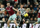 Newcastle United and West Ham United battling for the ball