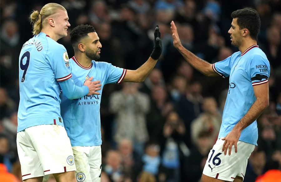 Man City players celebrate scoring against Aston Villa