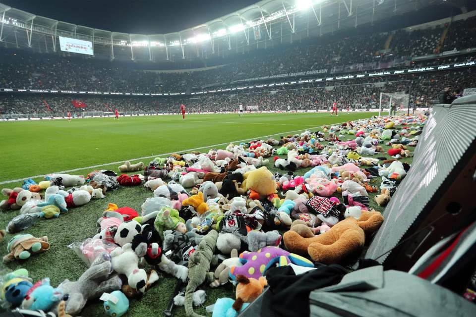 Besiktas fans shower the pitch with thousands of toys for earthquake-hit Syria and Türkiye during football match