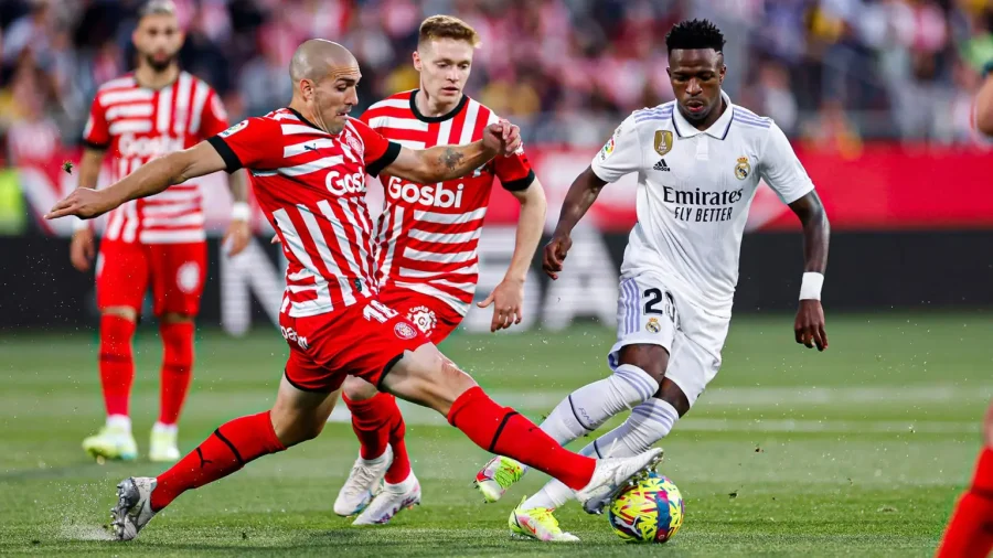 Girona and Real Madrid players jostling for possession