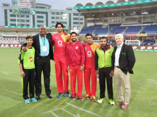 Ian Bishop poses with players during PSL game