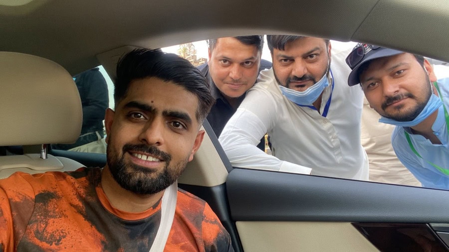 Babar Azam takes a picture with members of Excise departments